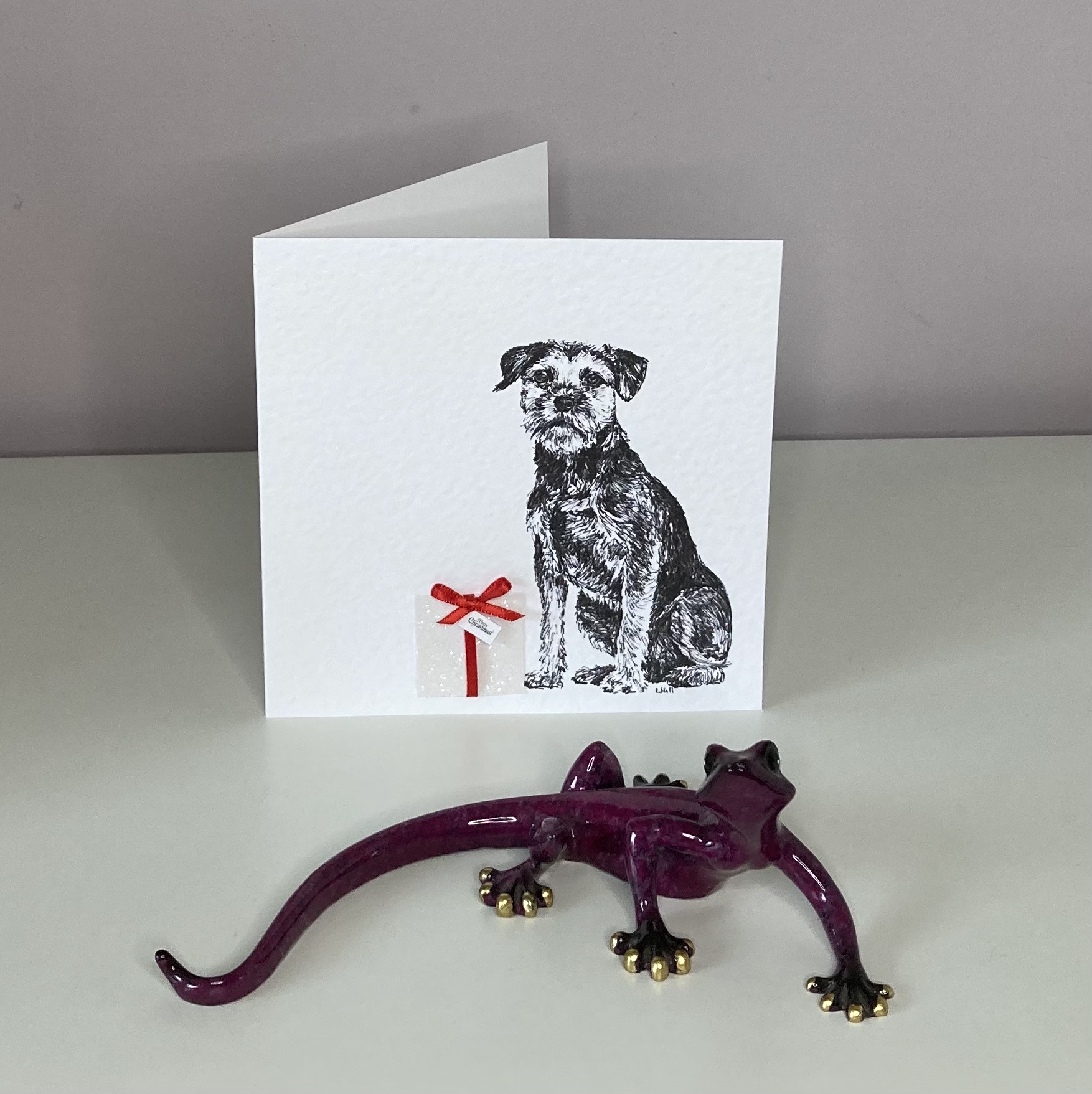 Border Terrier with Christmas present Christmas card by Louisa Hill