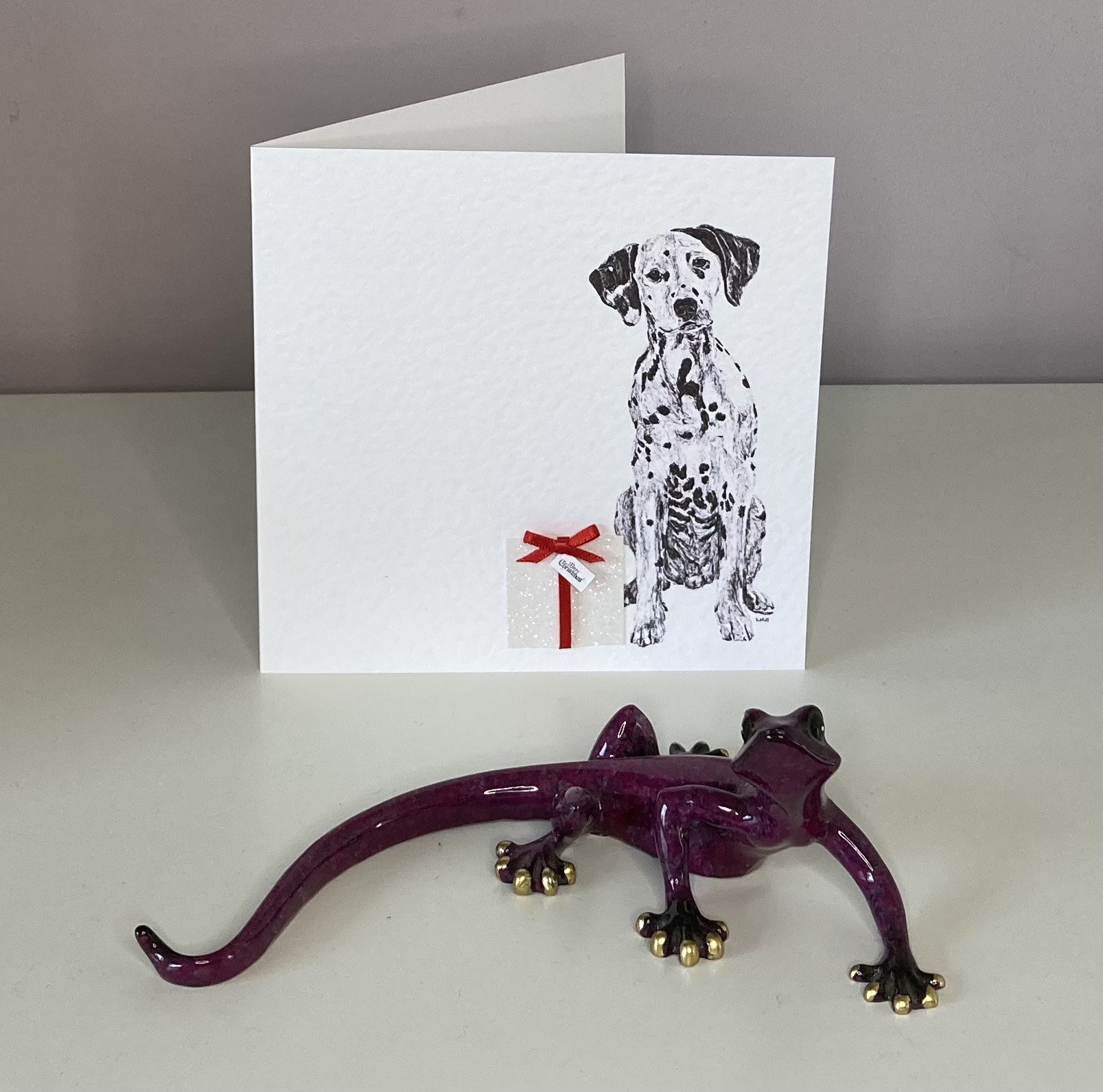 Dalmatian with Christmas present Christmas card by Louisa Hill